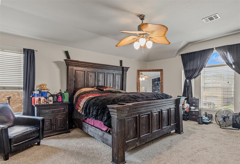503 Pinto Lane Forney, TX 75126 - Photo 11 of 20 a bedroom with bed and a chandelier
