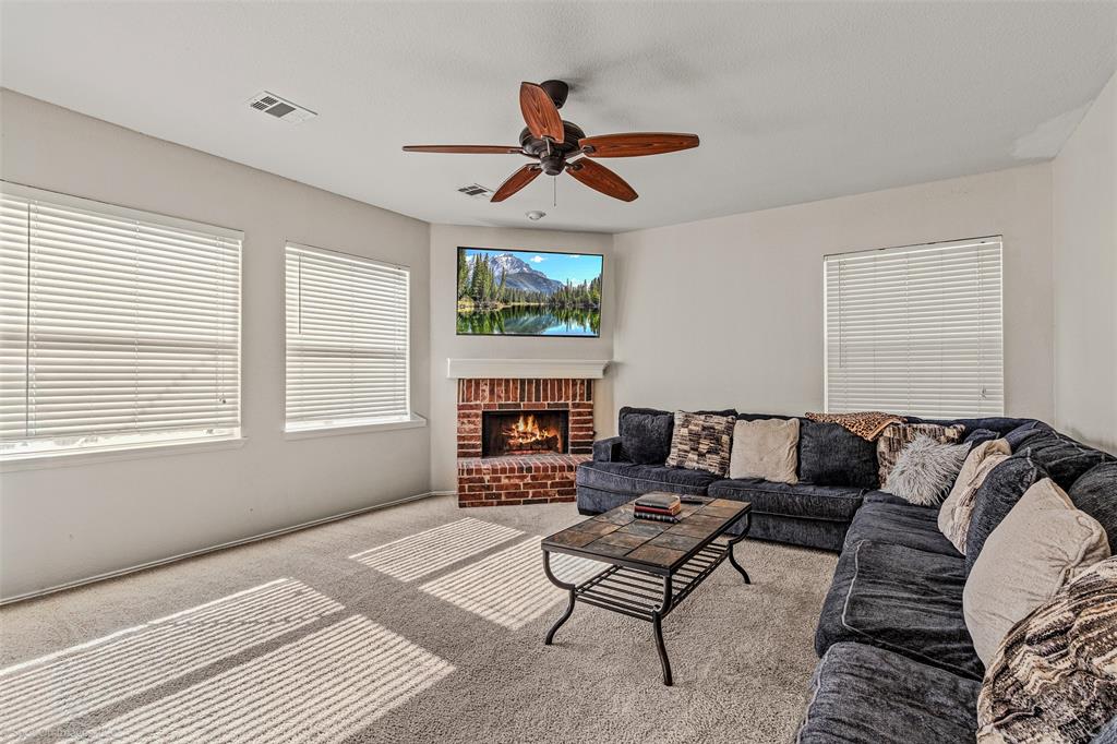 503 Pinto Lane Forney, TX 75126 - Photo 5 of 20 a living room with furniture a fireplace and a window