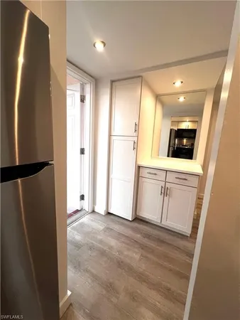 a view of a kitchen with a sink and a refrigerator