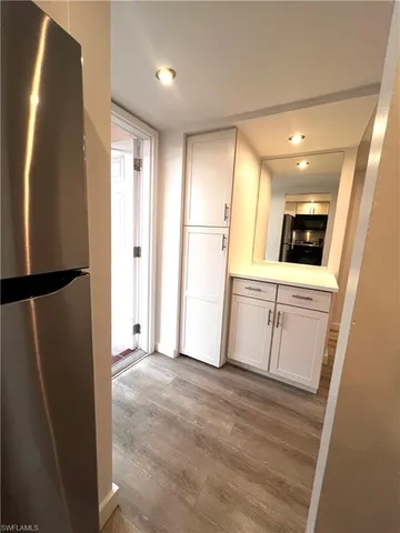 a view of a kitchen with a sink and a refrigerator