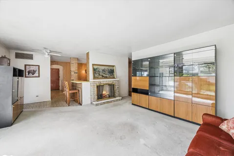 a living room with furniture and a baby crib