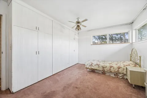 a bedroom with furniture and a chandelier
