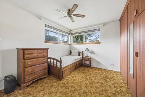 a view of washer and dryer with bathroom in the background