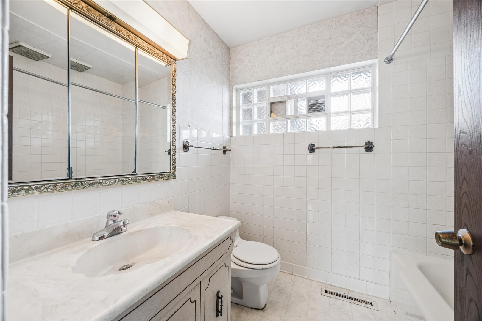 9135 West 26th Place Brookfield, IL 60513 - Photo 18 of 35 a bathroom with a sink a toilet and shower
