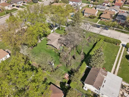 a view of house with backyard and a garden