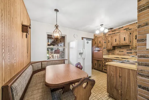 a dining room with furniture a chandelier and window