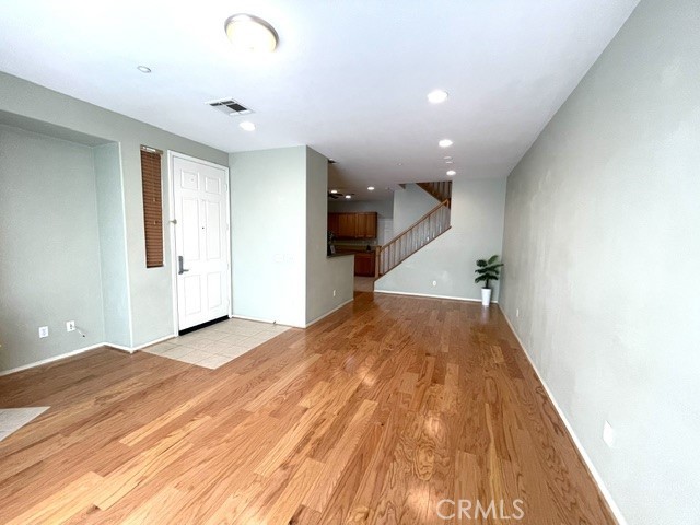 8692 East 9th Street, Unit 56 Rancho Cucamonga, CA 91730 - Photo 12 of 34 a view of a big room with wooden floor and staircase