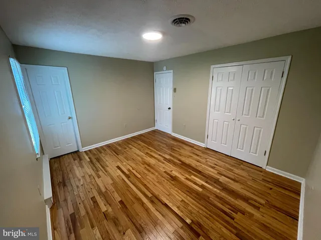 a view of hallway with wooden floor