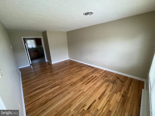 an empty room with wooden floor and closet