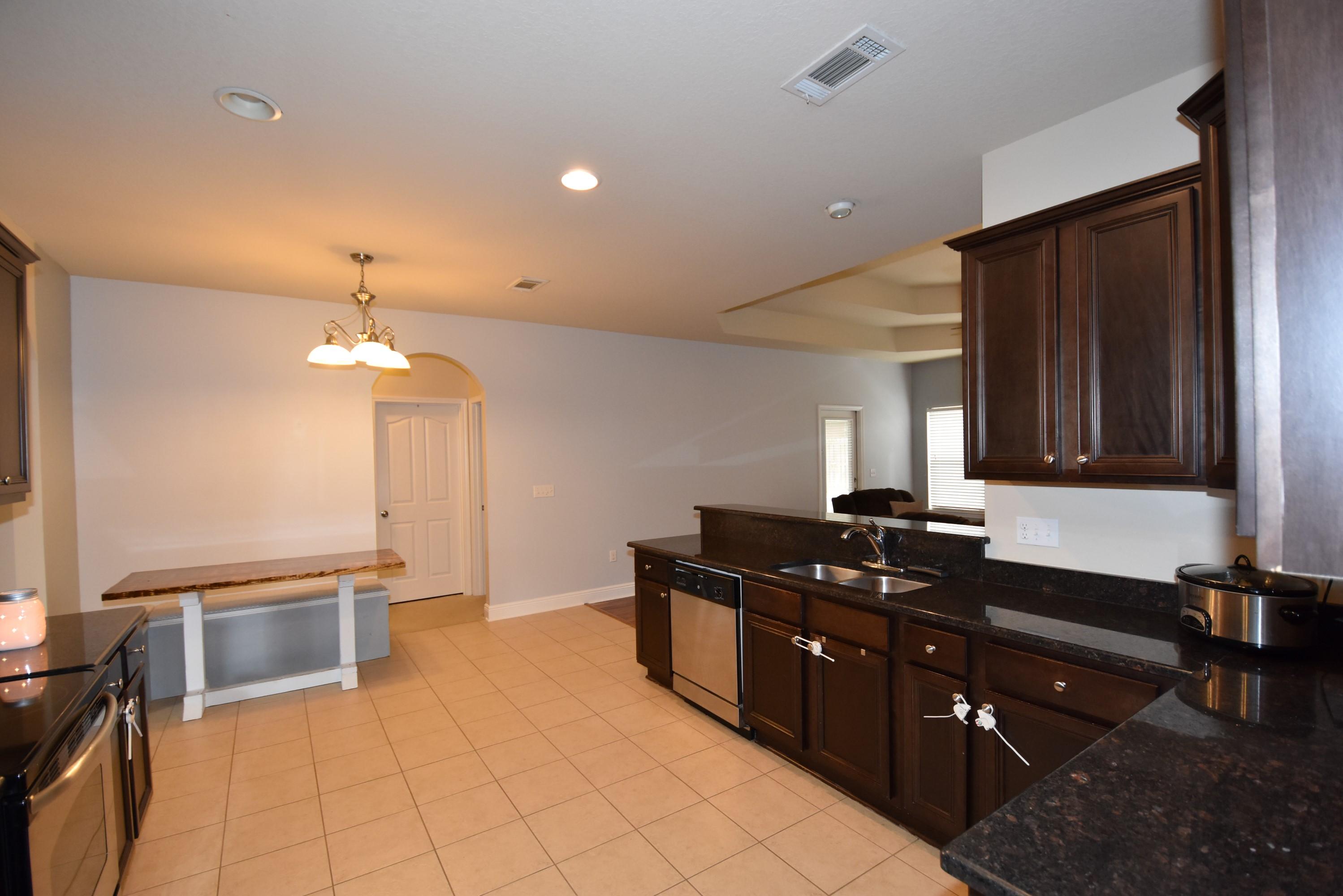 640 Red Fern Road Crestview, FL 32536 - Photo 16 of 50 a kitchen with a sink stove and cabinets