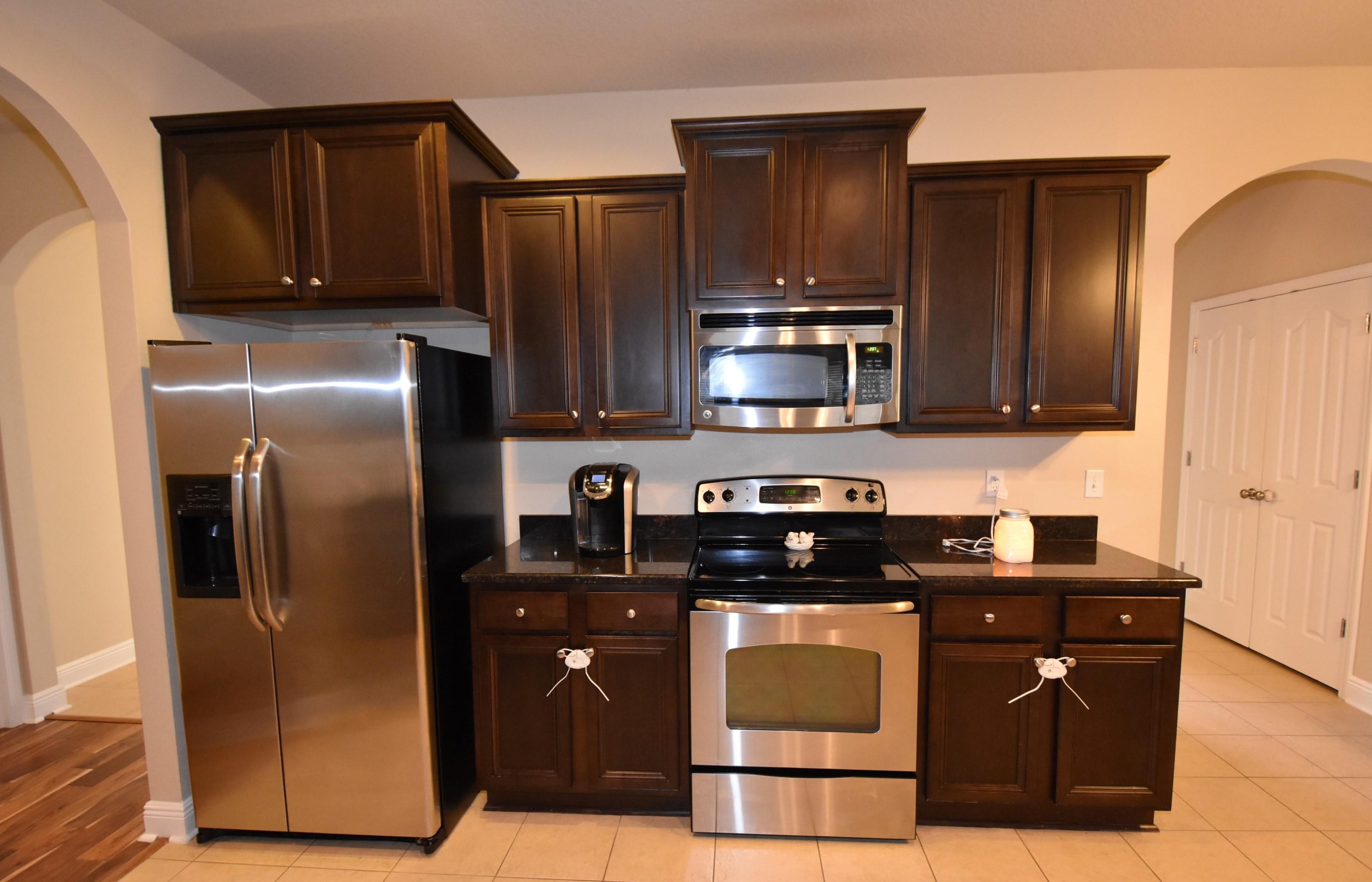 640 Red Fern Road Crestview, FL 32536 - Photo 17 of 50 a kitchen with stainless steel appliances granite countertop a refrigerator and a stove top oven