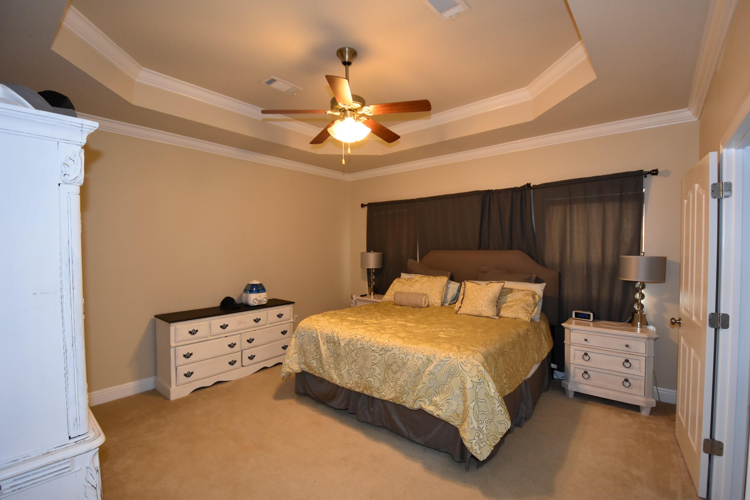640 Red Fern Road Crestview, FL 32536 - Photo 19 of 50 a bedroom with a bed and a ceiling fan