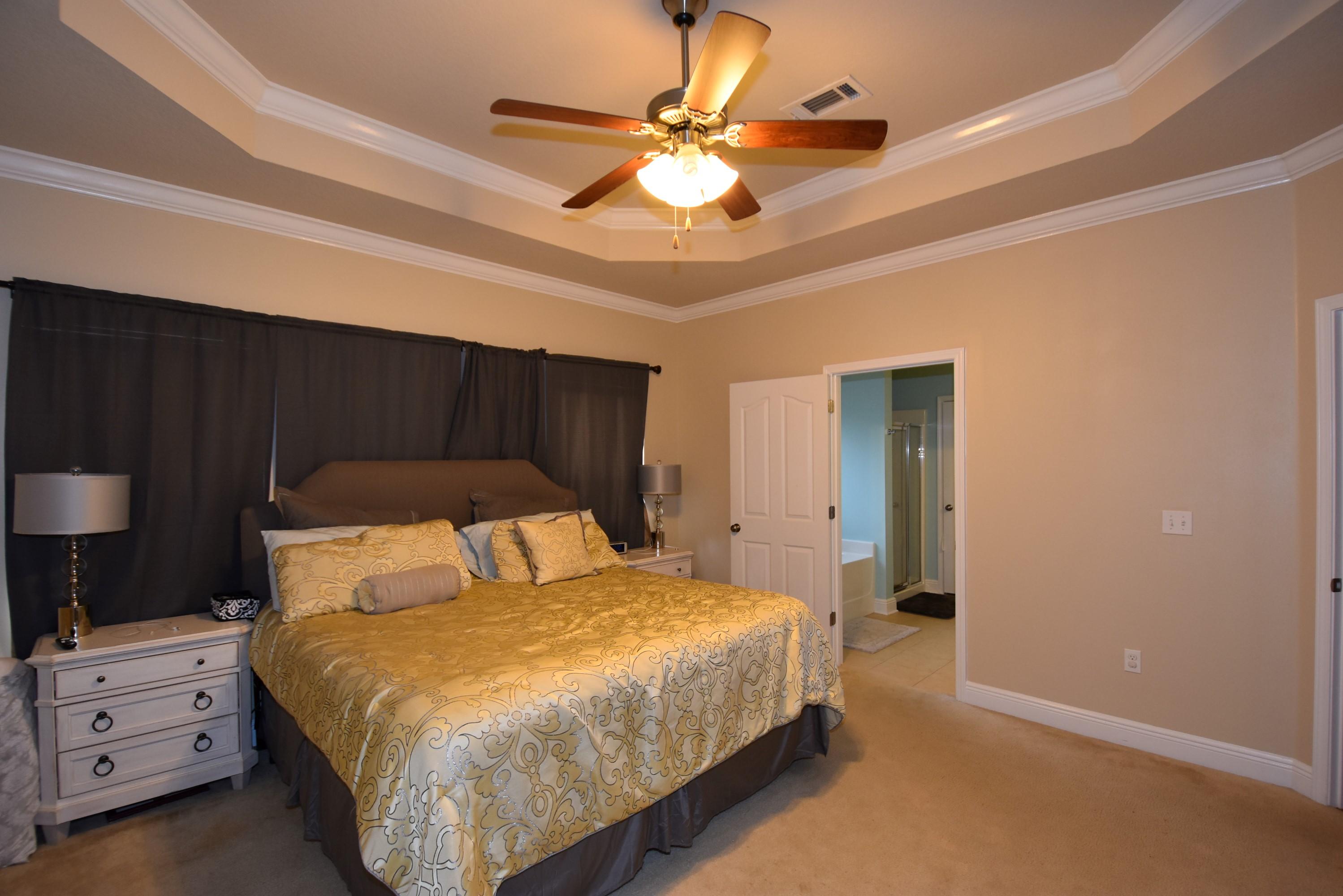 640 Red Fern Road Crestview, FL 32536 - Photo 20 of 50 a bedroom with a bed and a chandelier