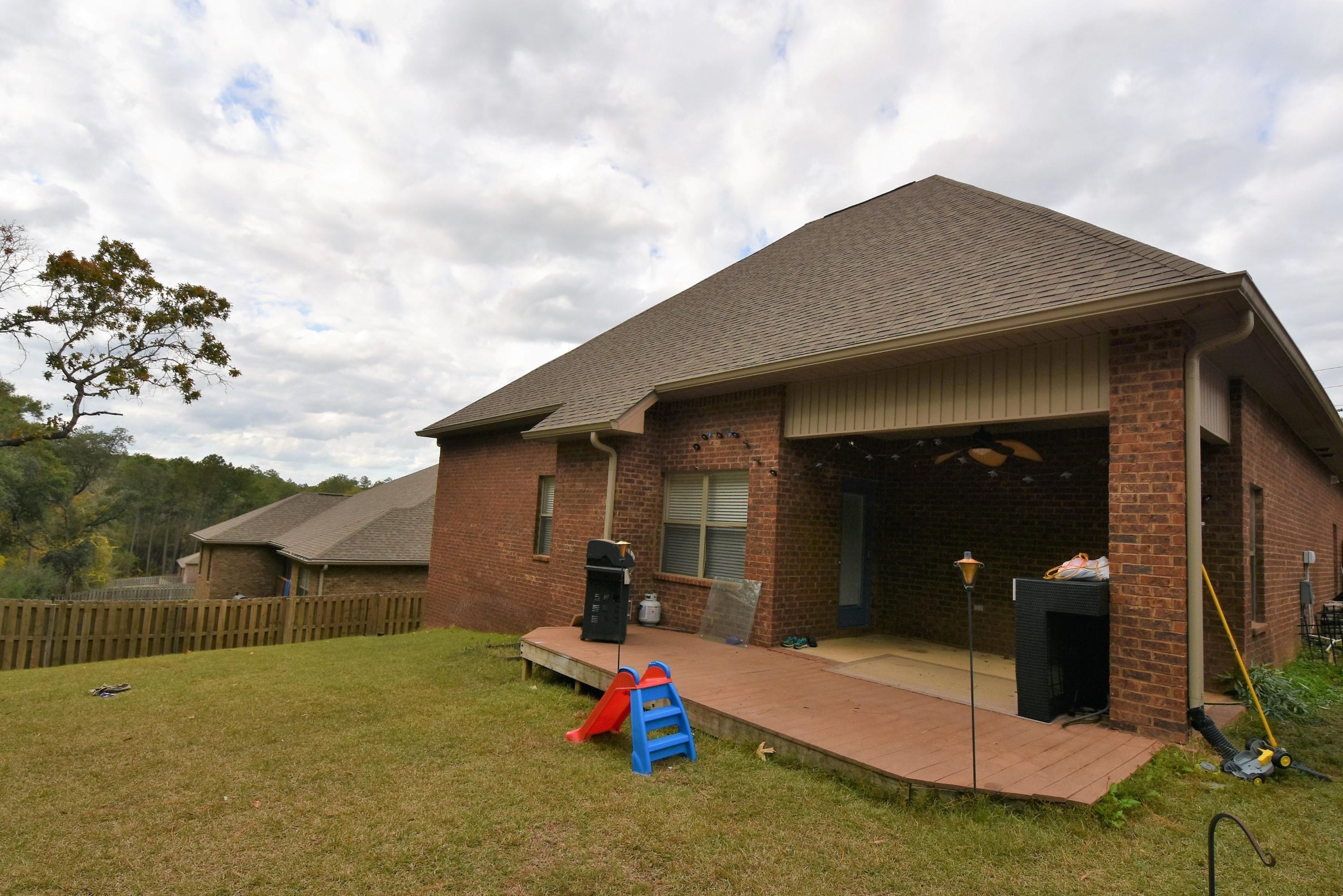 640 Red Fern Road Crestview, FL 32536 - Photo 2 of 50 a backyard of a house with table and chairs