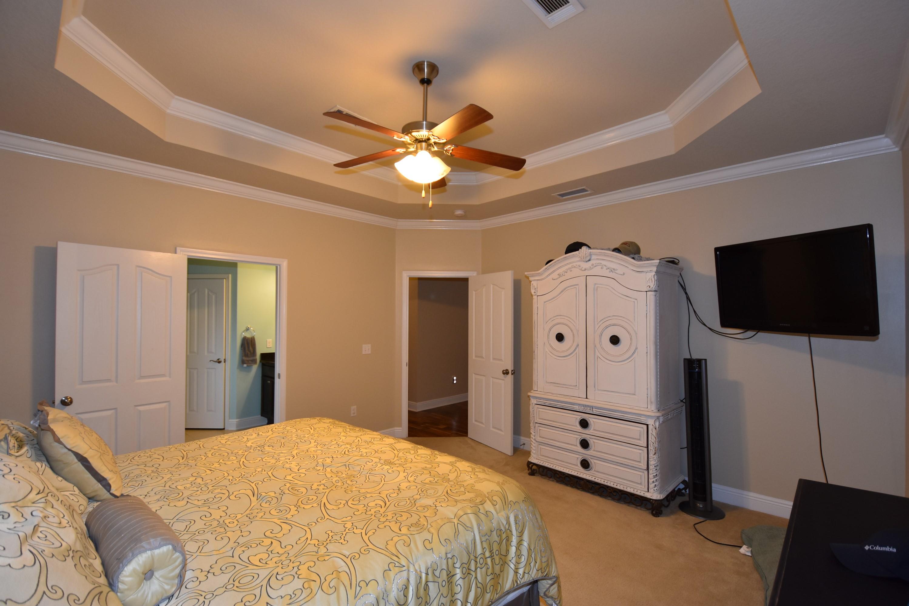 640 Red Fern Road Crestview, FL 32536 - Photo 21 of 50 a bedroom with a bed and a flat screen tv