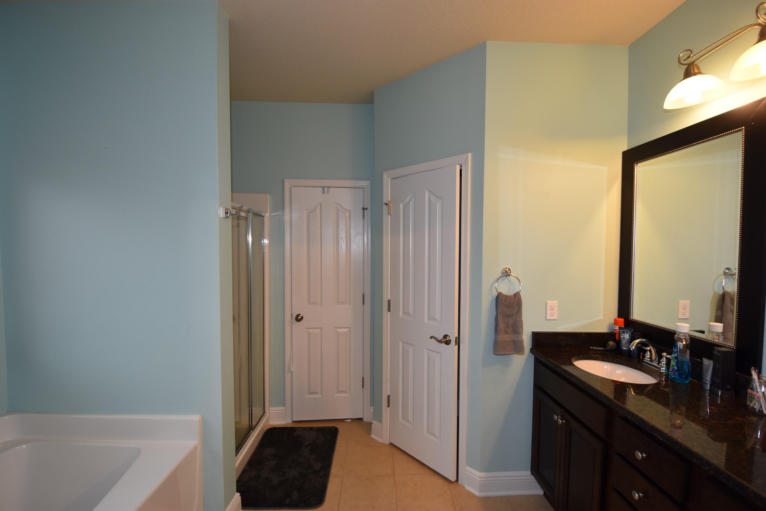 640 Red Fern Road Crestview, FL 32536 - Photo 22 of 50 a bathroom with a double vanity sink a mirror and a bathtub