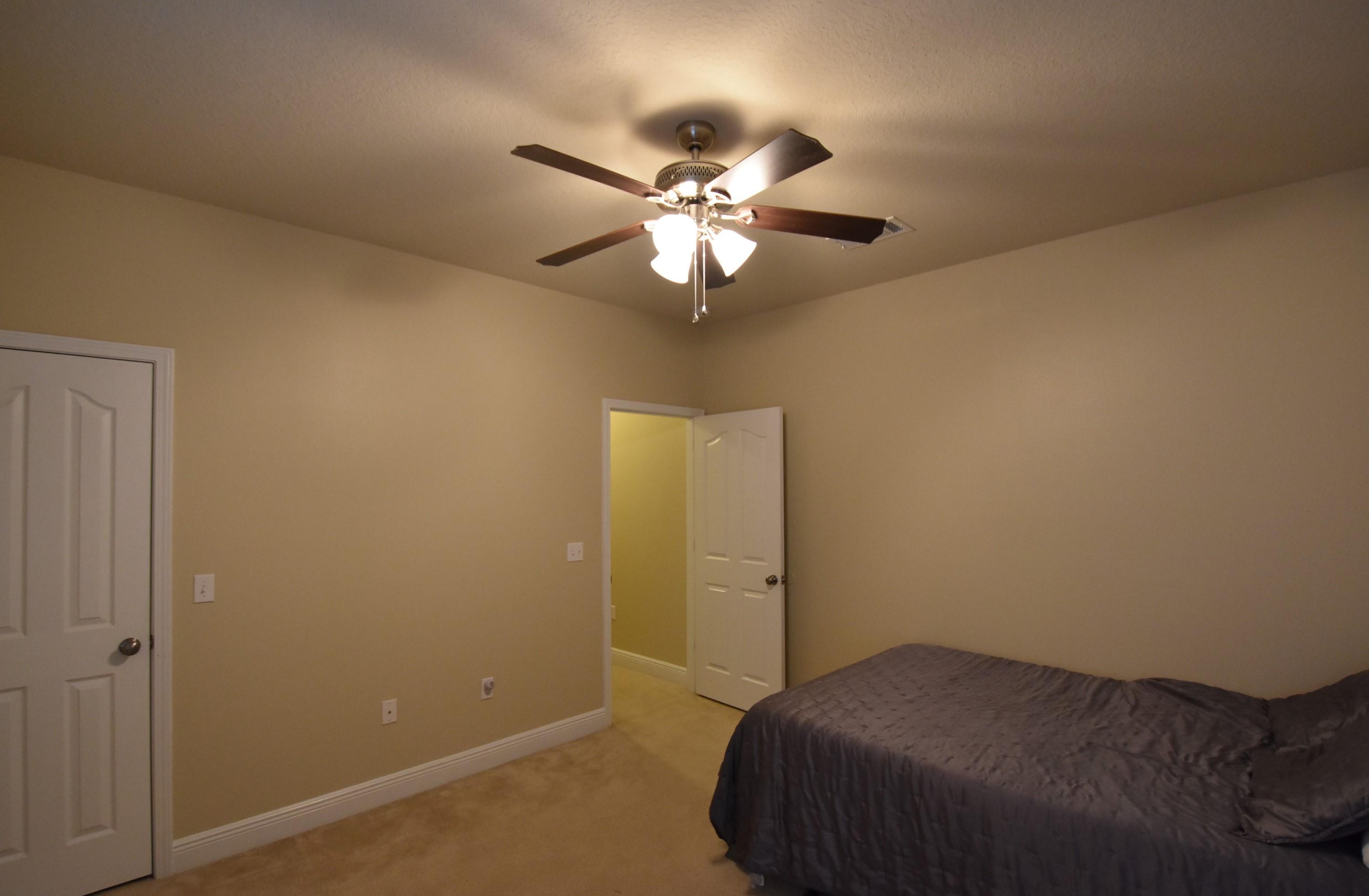 640 Red Fern Road Crestview, FL 32536 - Photo 29 of 50 a bedroom with a bed and a chandelier fan