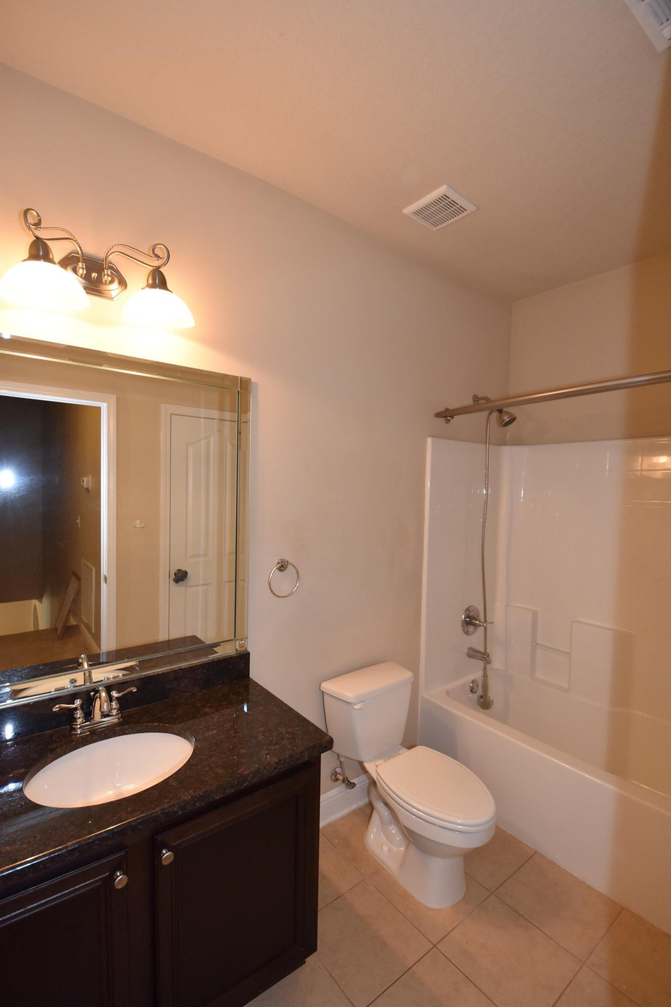 640 Red Fern Road Crestview, FL 32536 - Photo 30 of 50 a bathroom with a granite countertop sink toilet and shower