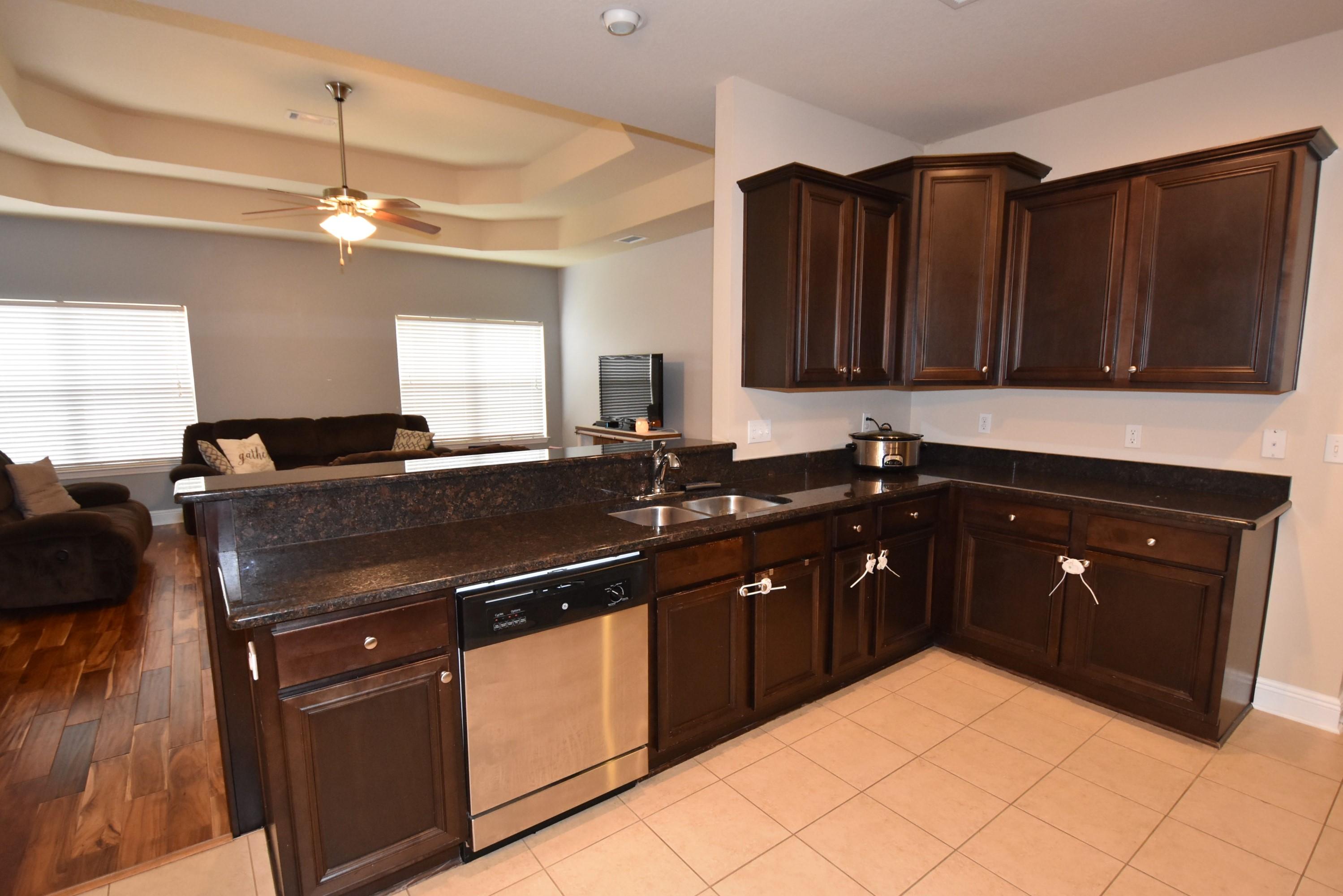 640 Red Fern Road Crestview, FL 32536 - Photo 44 of 50 a kitchen with a sink and a refrigerator