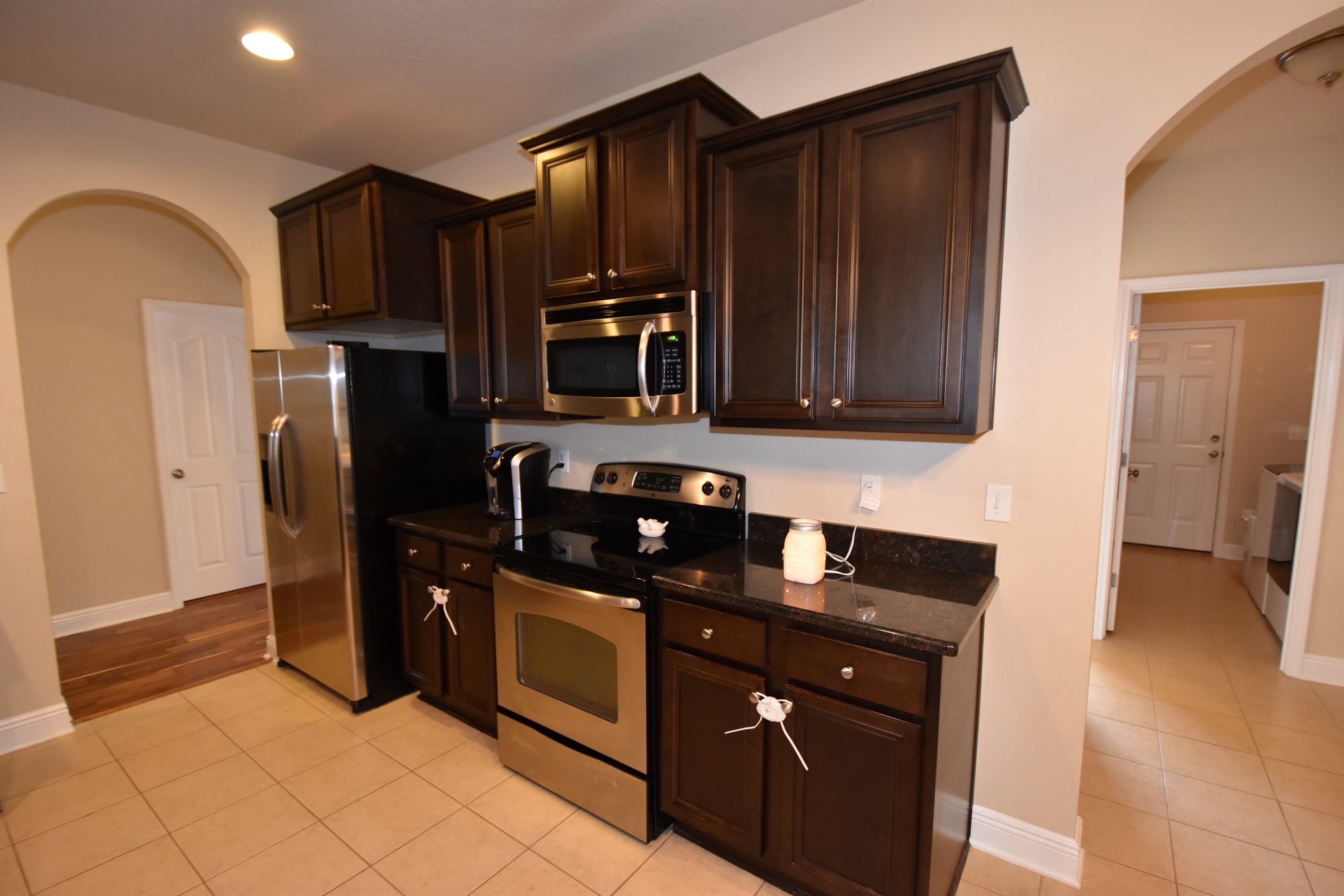 640 Red Fern Road Crestview, FL 32536 - Photo 45 of 50 a kitchen with stainless steel appliances granite countertop a refrigerator and a stove top oven