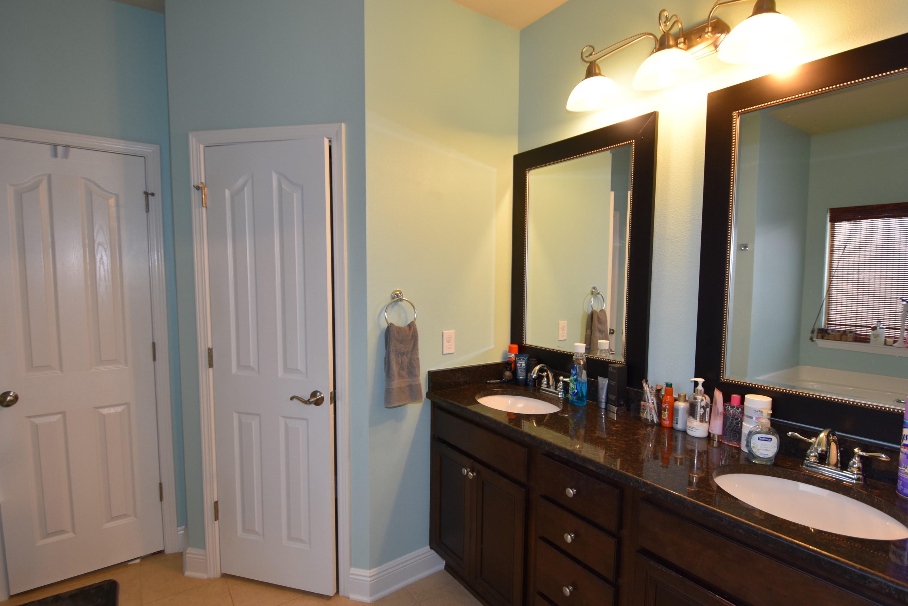 640 Red Fern Road Crestview, FL 32536 - Photo 47 of 50 a bathroom with double vanity sinks a mirror and a shower