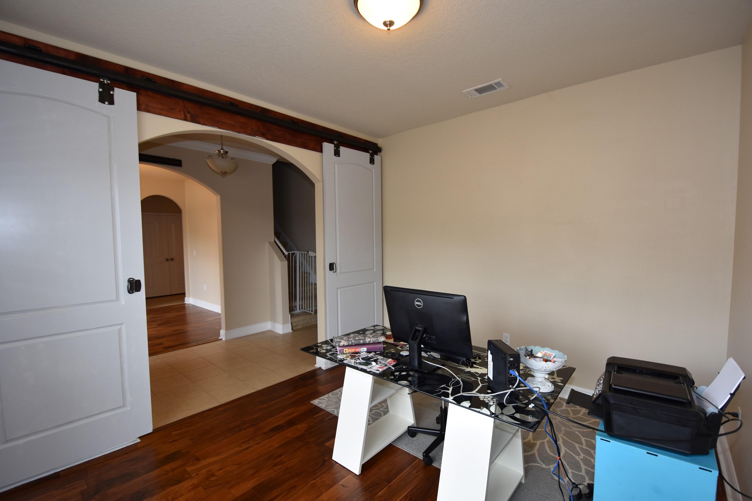 640 Red Fern Road Crestview, FL 32536 - Photo 7 of 50 a view of a workspace with furniture and wooden floor