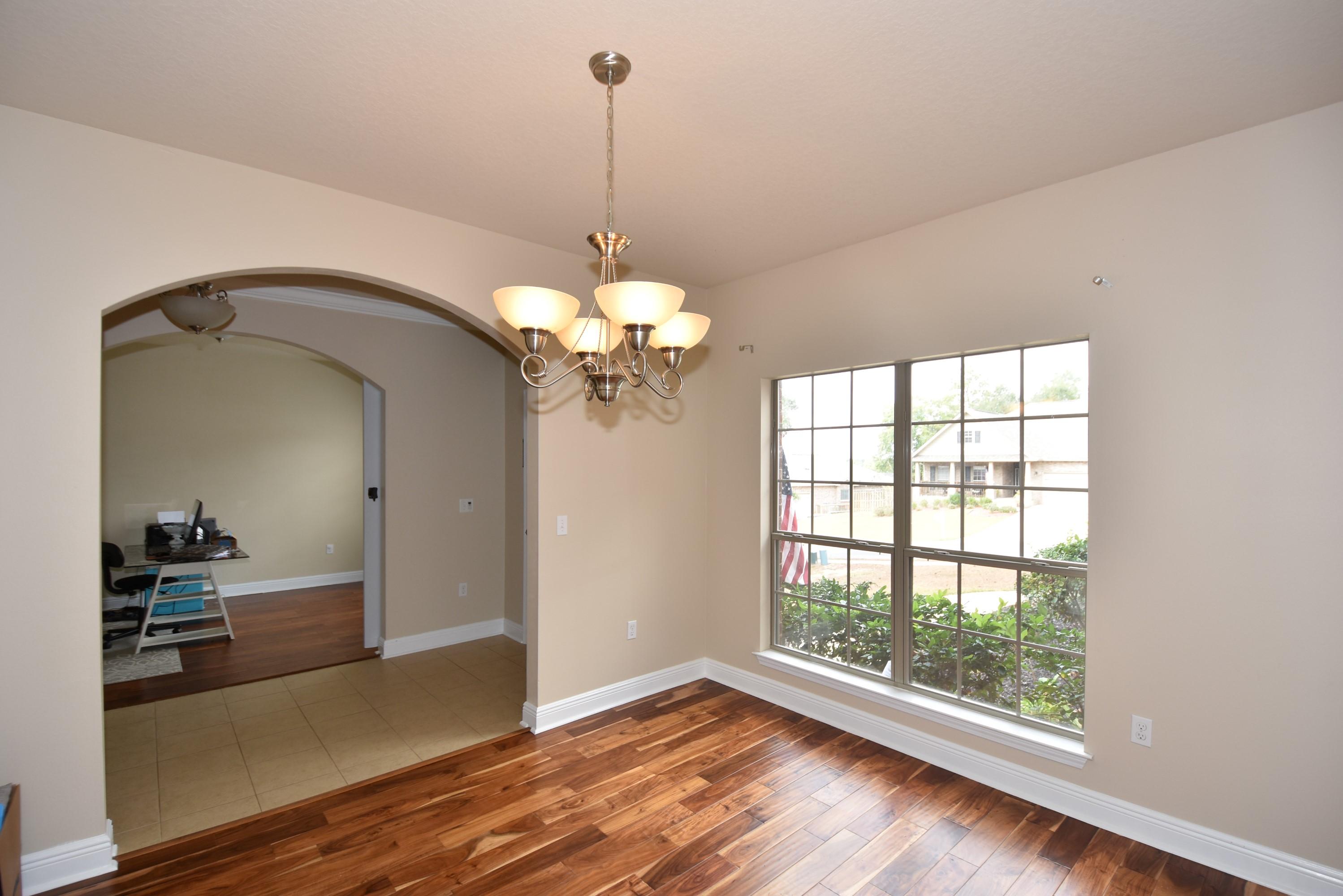 640 Red Fern Road Crestview, FL 32536 - Photo 9 of 50 a view of a livingroom with a chandelier wooden floor and a chandelier