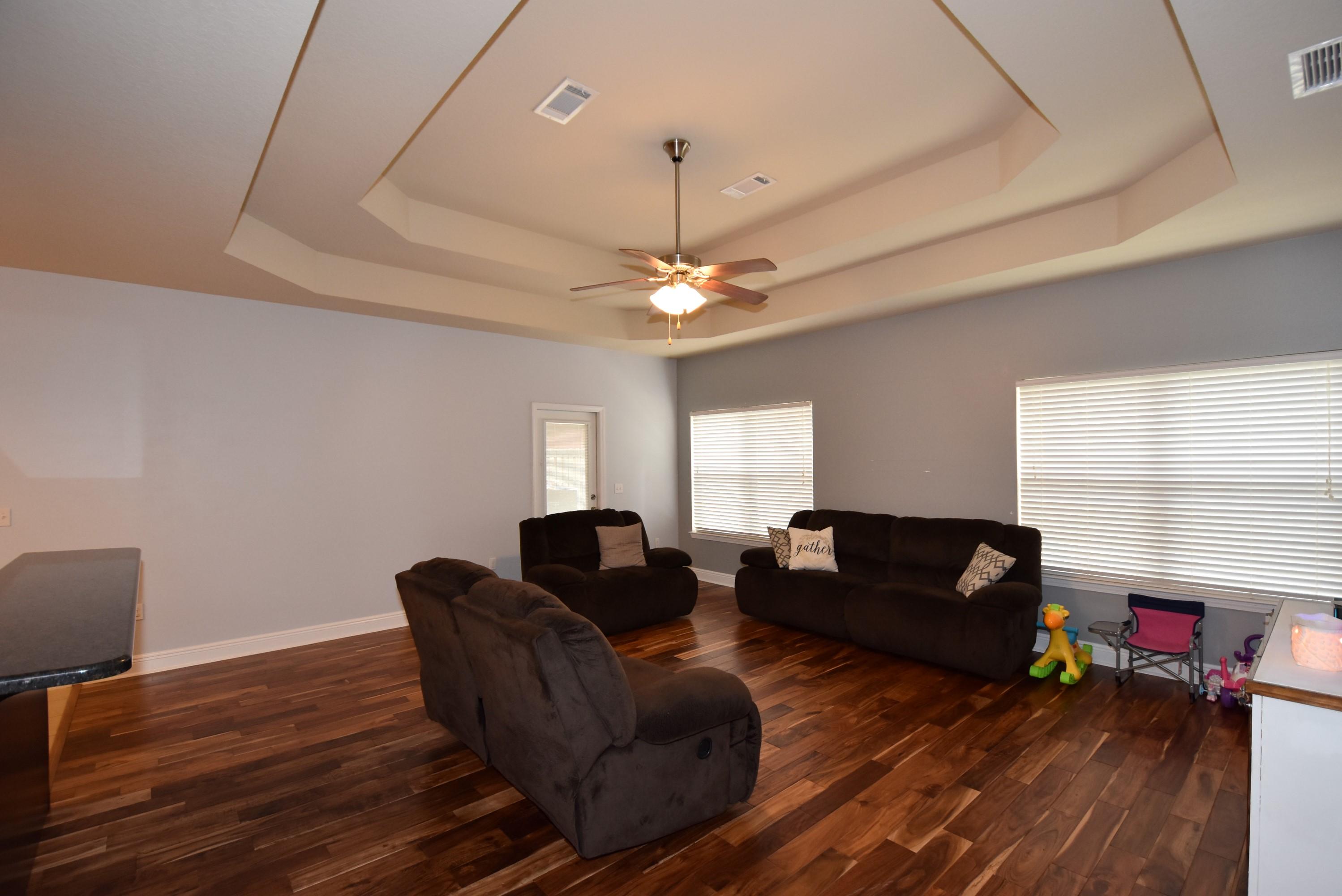 640 Red Fern Road Crestview, FL 32536 - Photo 10 of 50 a living room with furniture and a chandelier