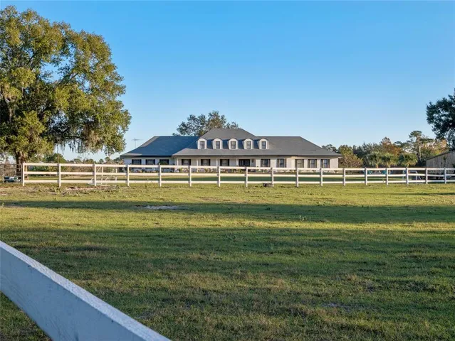 a view of swimming pool with a yard and plants