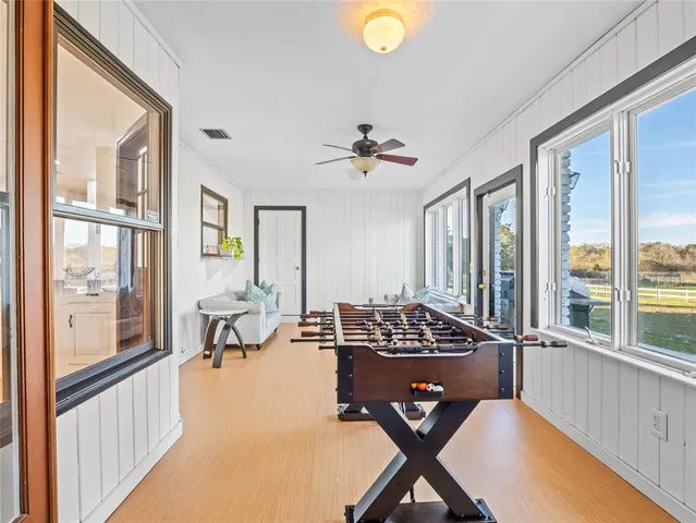 an aerial view of residential houses with outdoor space and trees