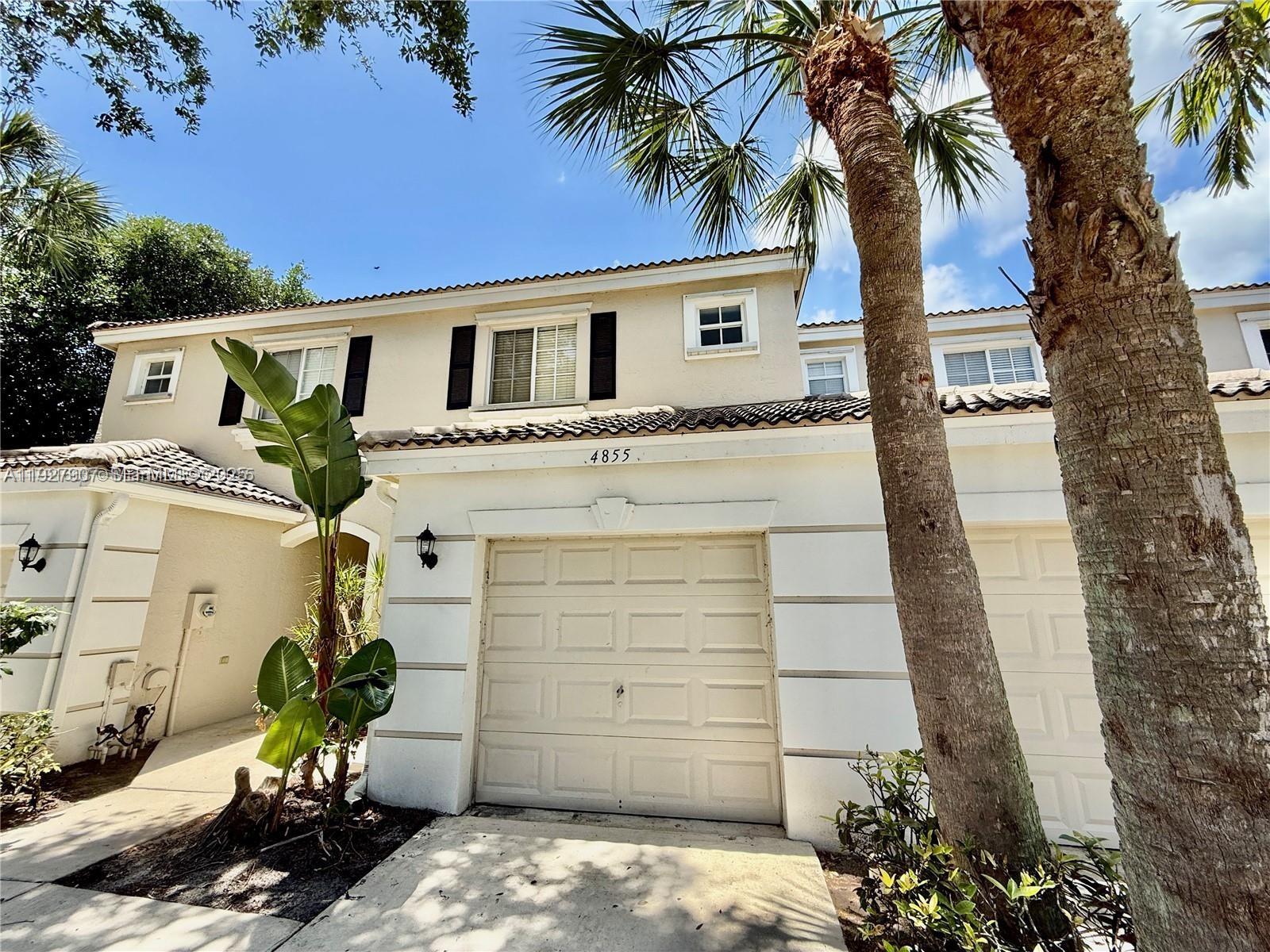 4855 Palmbrooke Circle, Unit 4855 West Palm Beach, FL 33417 - Photo 1 of 40 a front view of a house with a yard