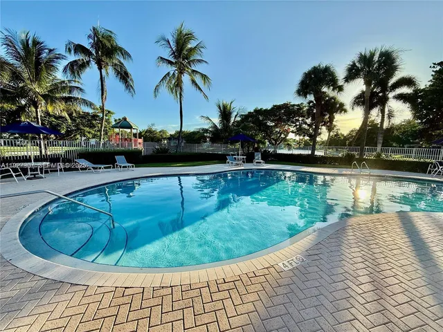 a view of a swimming pool with a yard