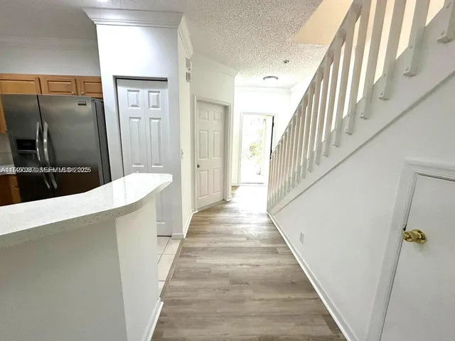 a view of a hallway with wooden floor