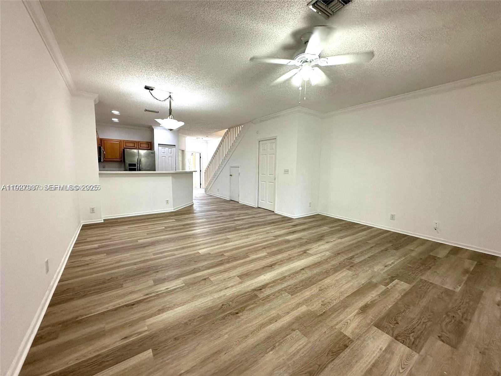 4855 Palmbrooke Circle, Unit 4855 West Palm Beach, FL 33417 - Photo 20 of 40 a view of empty room with wooden floor
