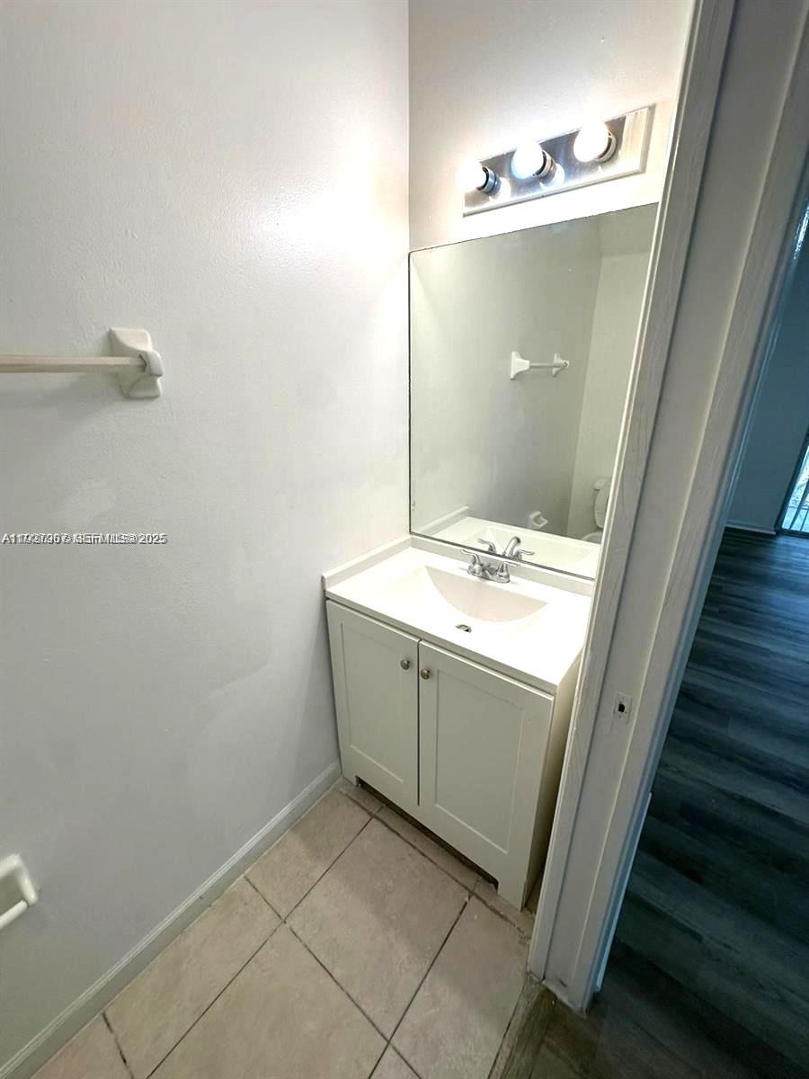 4855 Palmbrooke Circle, Unit 4855 West Palm Beach, FL 33417 - Photo 23 of 40 a bathroom with a sink and mirror