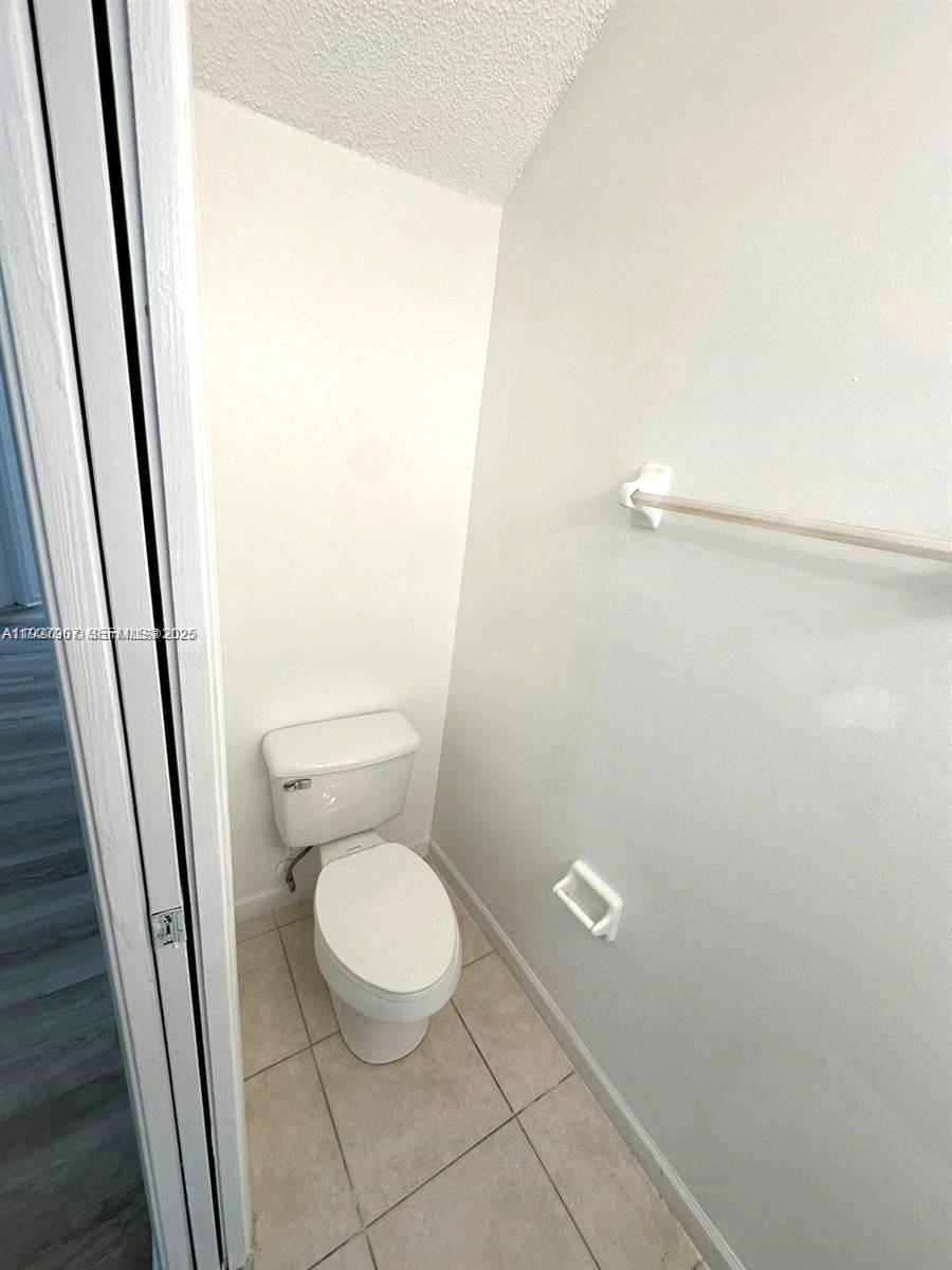 4855 Palmbrooke Circle, Unit 4855 West Palm Beach, FL 33417 - Photo 24 of 40 a white toilet sitting next to a shower