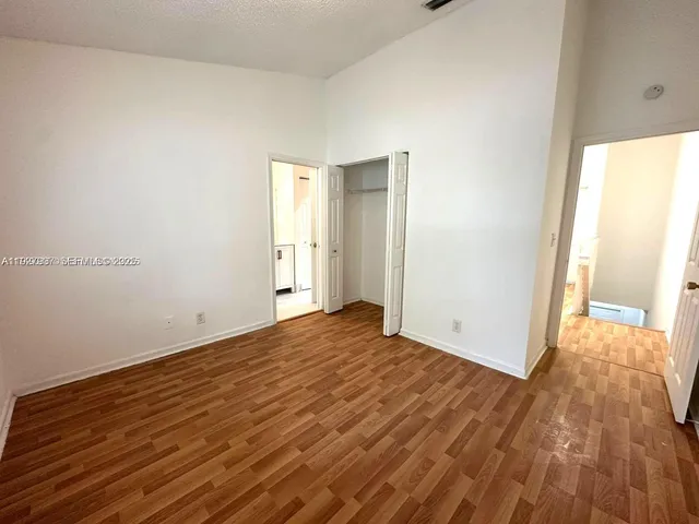 a view of an empty room and wooden floor