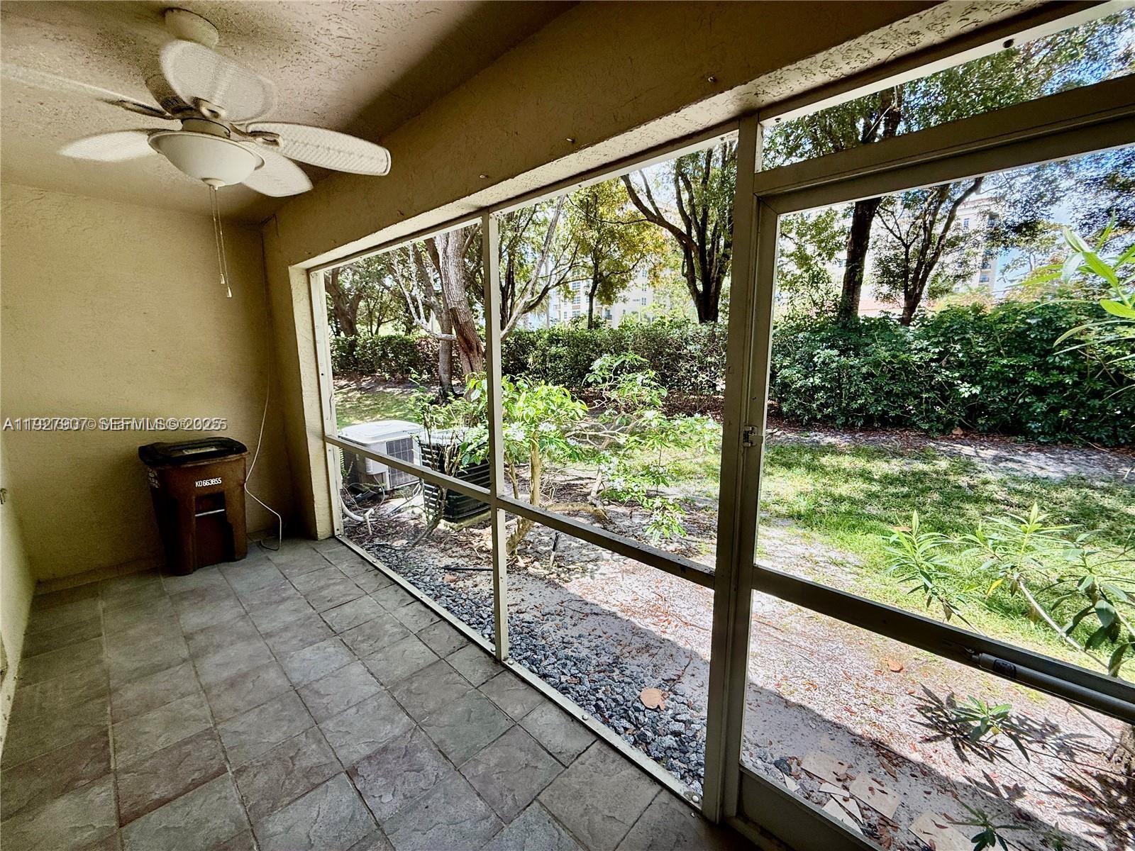 4855 Palmbrooke Circle, Unit 4855 West Palm Beach, FL 33417 - Photo 39 of 40 a view of a porch and garden