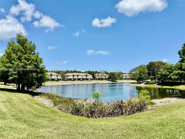a view of a lake with a house in the background