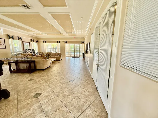a lobby with furniture and floor to ceiling window