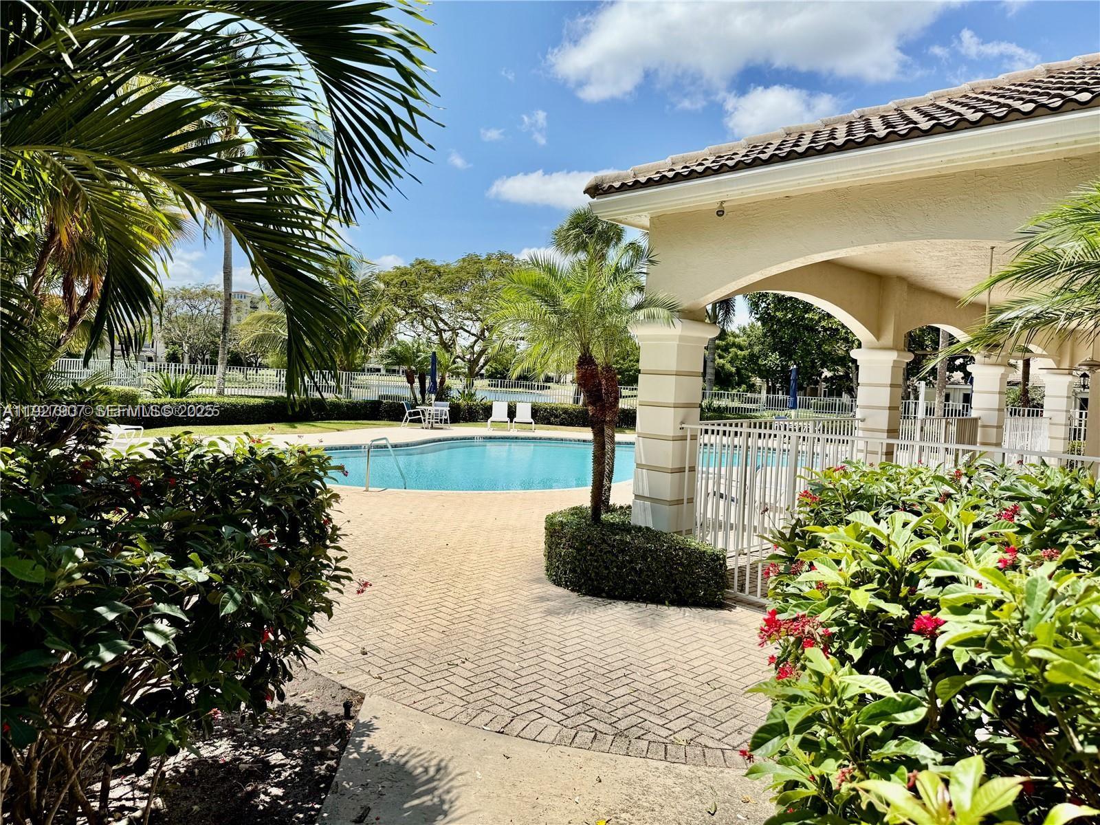 4855 Palmbrooke Circle, Unit 4855 West Palm Beach, FL 33417 - Photo 10 of 40 a front view of a house with garden