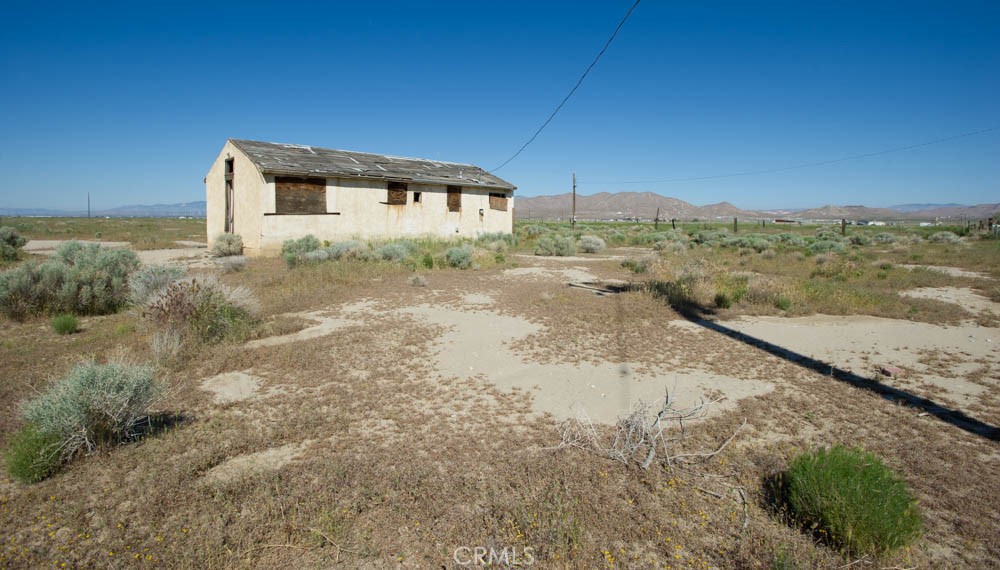 2011 67th Street West Rosamond, CA 93560 - Photo 5 of 11 a view of a dry yard with wooden fence