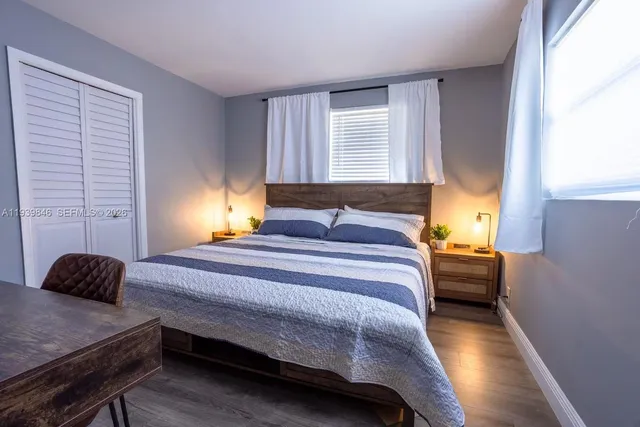 a bedroom with a bed and a window