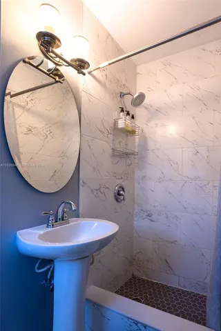 a bathroom with a sink and mirror