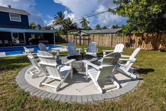 a view of a swimming pool with outdoor seating and plants