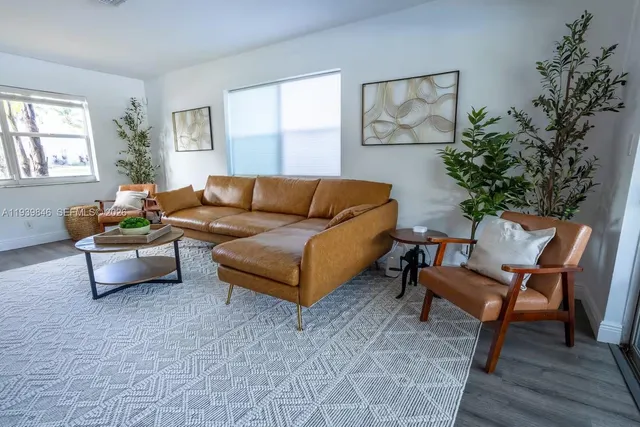 a living room with furniture and a potted plant