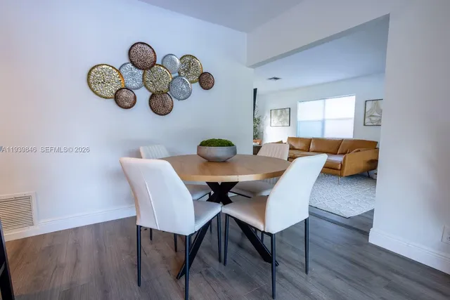 a view of a dining room with furniture and chandelier