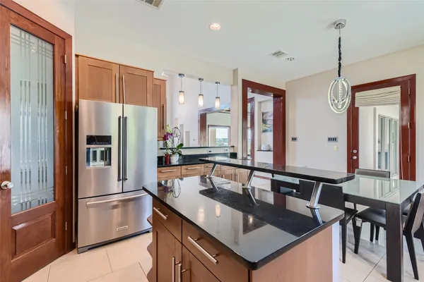 a spacious bedroom with a bed a couch and a large window
