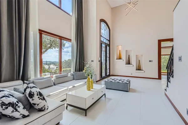 a kitchen with stainless steel appliances a table chairs and a refrigerator