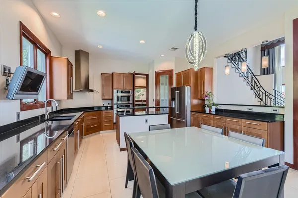 a spacious bedroom with a bed couch and a large window